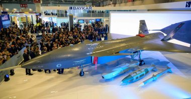 Visitors stand looking at Baykar&#039;s unmanned fighter jet, Kızılelma, during the opening day of the SAHA EXPO 2024, an international defense and aerospace exhibition, in Istanbul, Türkiye, Oct. 22, 2024. (AFP Photo)