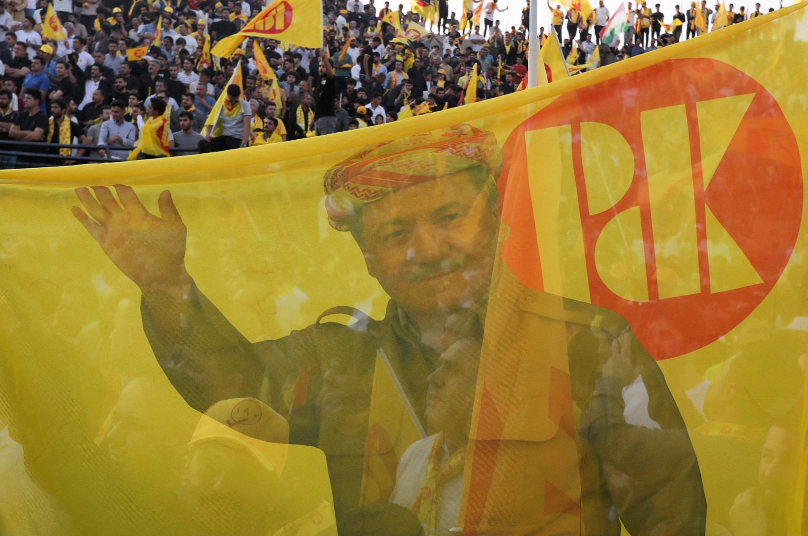 Iraqi Kurds wave flags as they attend an electoral campaign for the Kurdistan Democratic Party (KDP) at a stadium in Irbil, Iraq, Oct. 15, 2024. (AFP Photo)