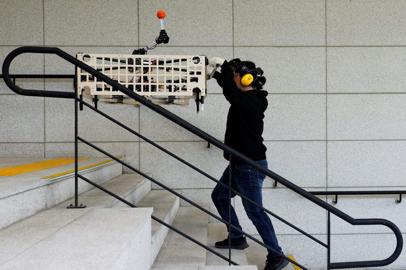 Park Hyun-geun, a graduate student of Mechanical Design and Robot Engineering, demonstrates the aerial transportation platform Palletrone on stairs, Seoul, South Korea, Oct. 10, 2024. (Reuters Photo)