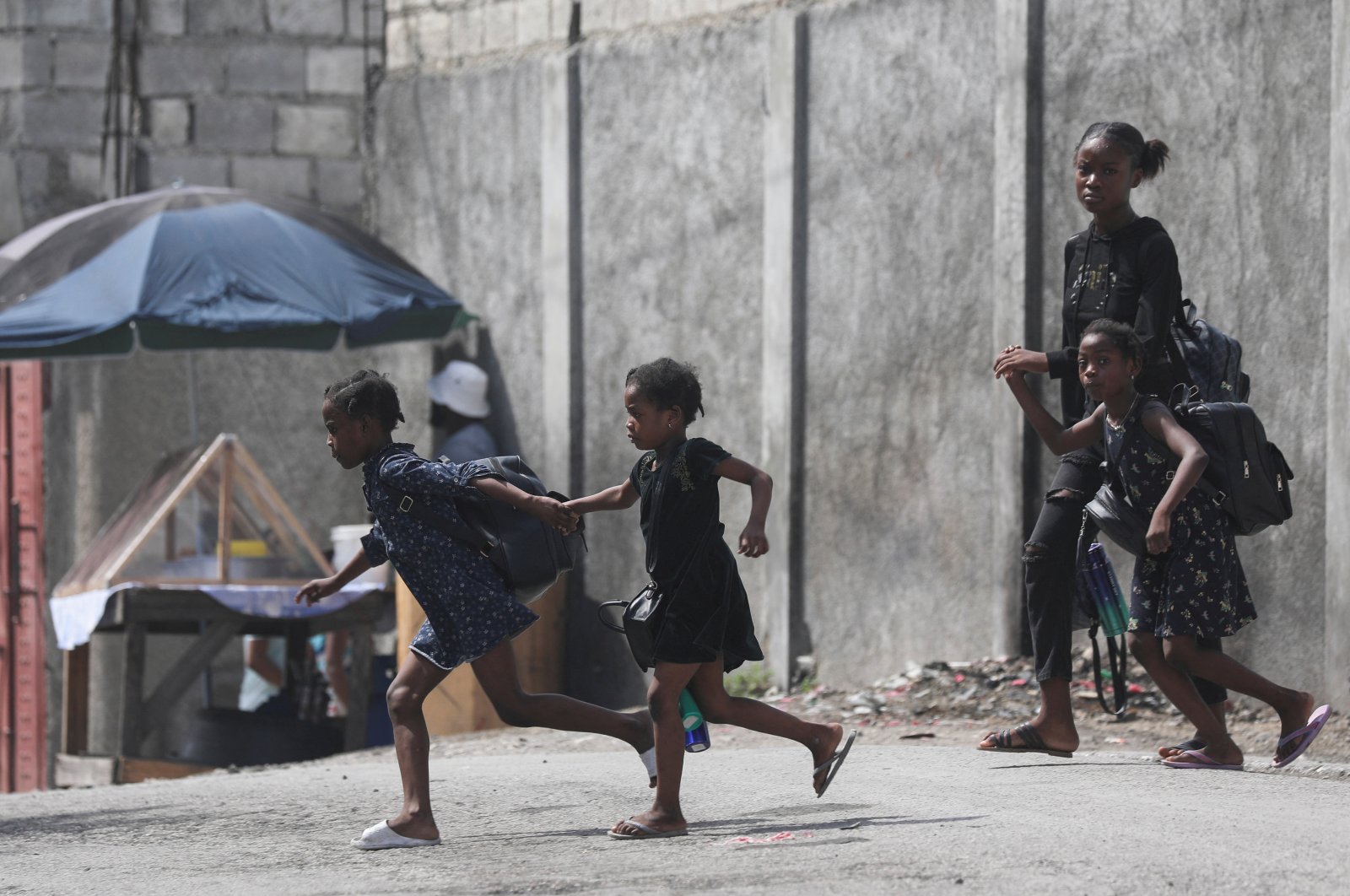 A woman and three children flee their home from gang violence, in Port-au-Prince, Haiti, Oct. 20, 2024. (Reuters Photo)