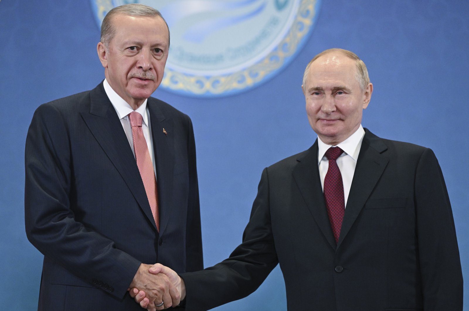 President Recep Tayyip Erdoğan and Russian President Vladimir Putin shake hands as they pose for photos during a meeting on the sidelines of the Shanghai Cooperation Organization summit, Astana, Kazakhstan, July 3, 2024. (AP Photo)