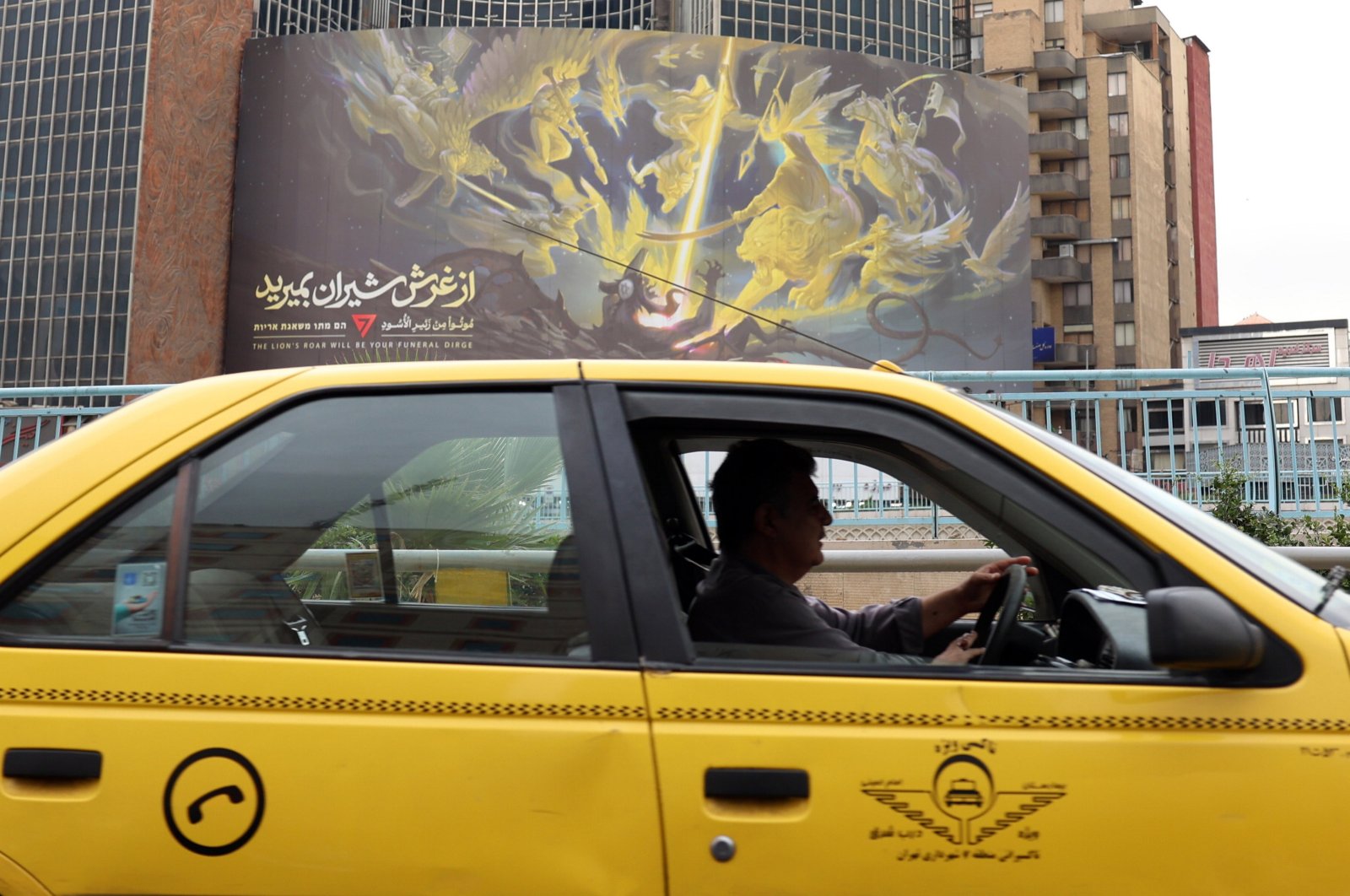 A taxi driver drives past an anti-Israeli billboard at the Valiasr Square in Tehran, Iran, Oct. 21, 2024. (EPA Photo)