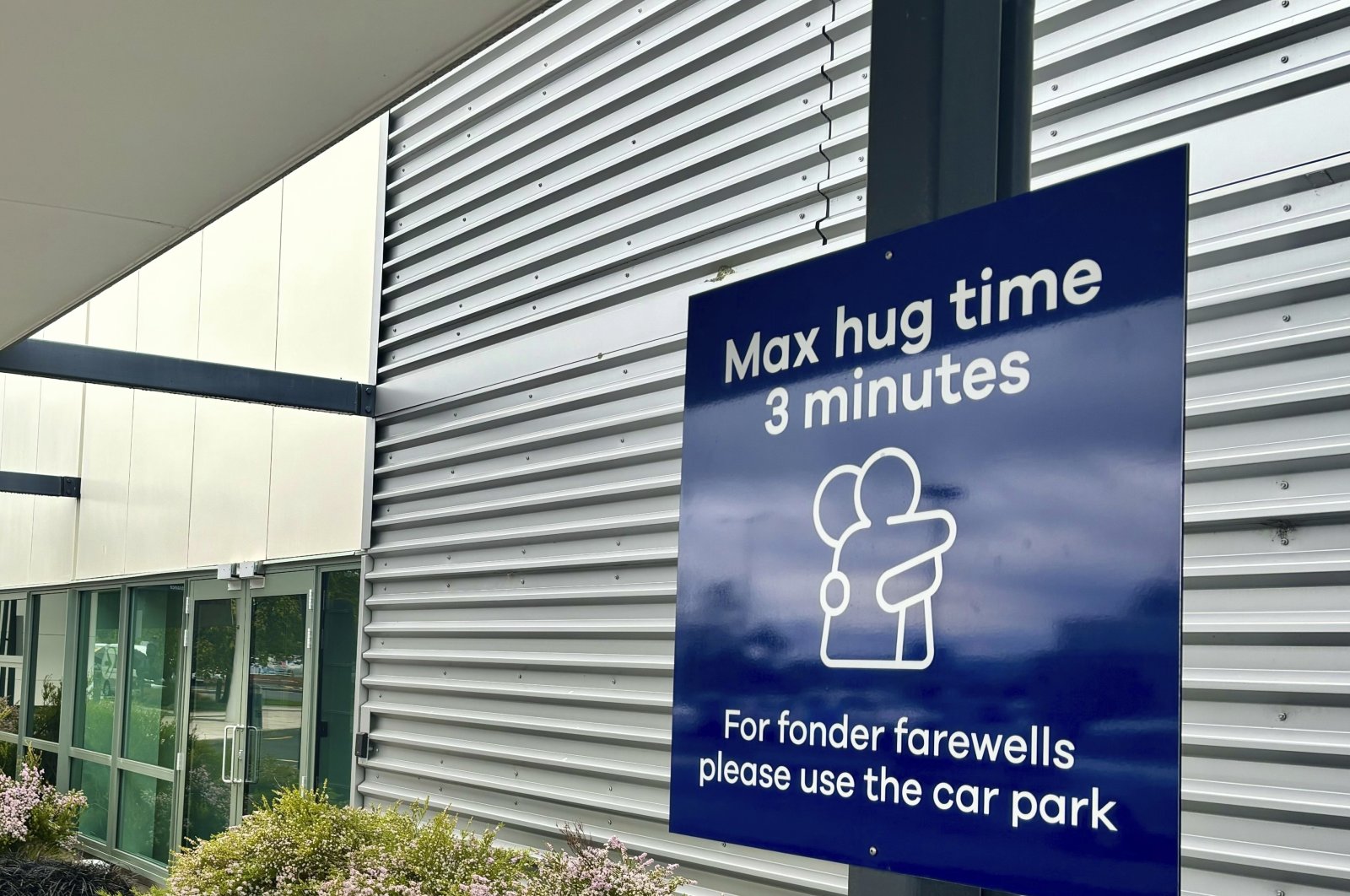 A sign outlining time limits for visitors to the passenger drop-off area outside Dunedin Airport, Momona, New Zealand, Oct. 22, 2024. (AP Photo)