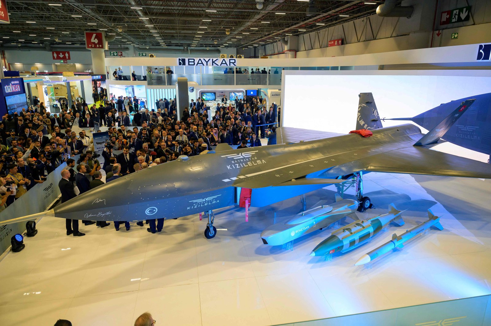 Visitors stand looking at Baykar&#039;s unmanned fighter jet, Kızılelma, during the opening day of the SAHA EXPO 2024, an international defense and aerospace exhibition, in Istanbul, Türkiye, Oct. 22, 2024. (AFP Photo)