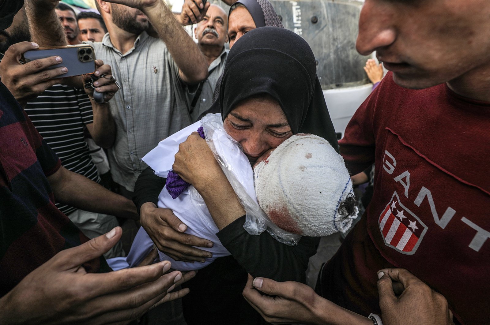 A Palestinian woman, grandmother of killed one-and-a-half-year old baby Yaman Al Zaneen, mourns while carrying his body during the funeral in Deir al-Balah, central Gaza Strip, Oct. 14, 2024. (EPA File Photo)