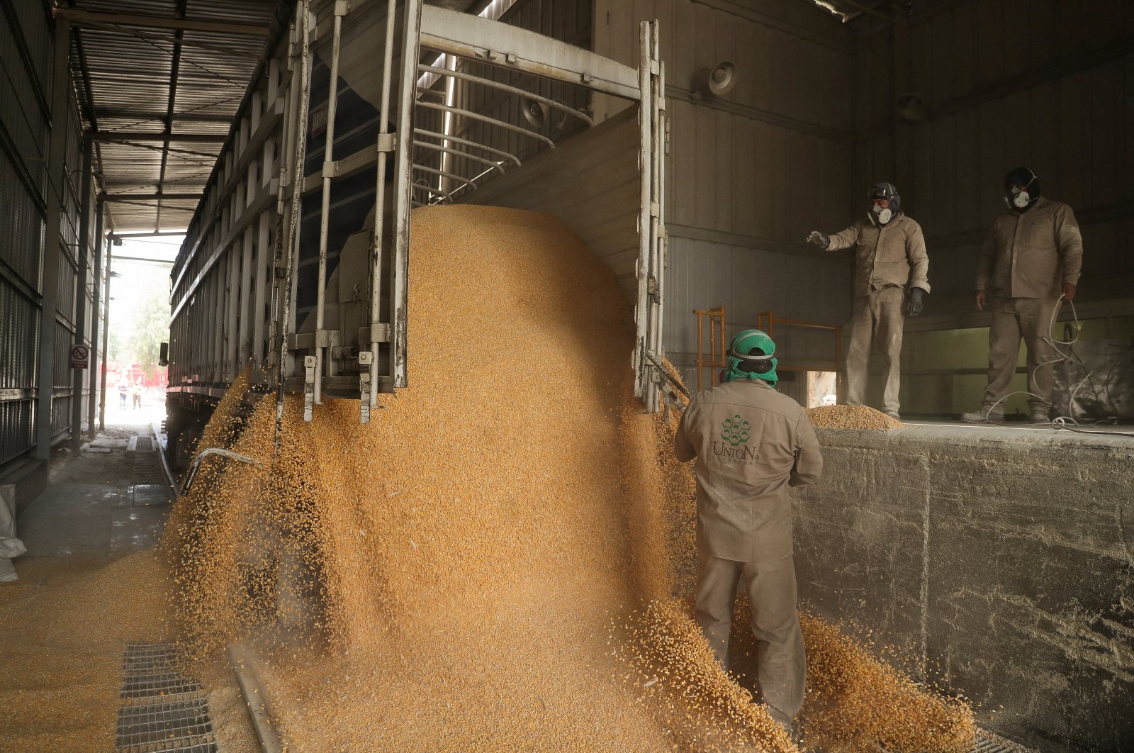 Workers unload a truck with GMO yellow corn imported from the U.S. at a cattle feed plant in Tepexpan, Mexico March 15, 2023. (Reuters File Photo)