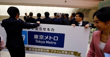 Staff of the Tokyo Stock Exchange carry a banner at a ceremony to mark Tokyo Metro’s debut on the Tokyo Stock Exchange, Tokyo, Japan, Oct. 23, 2024. (Reuters Photo)