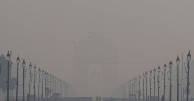 People walk on the Kartavya Path amid the morning smog in New Delhi, India, Oct. 23, 2024. (Reuters Photo)