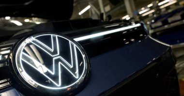 The Volkswagen logo is illuminated on a production line for the Golf VIII and Tiguan cars at the VW headquarters, Wolfsburg, Germany, May 23, 2024. (Reuters Photo)