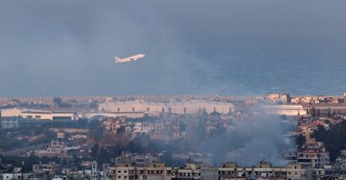 A Lebanese Middle East Airlines (MEA) plane takes off from Beirut-Rafic Hariri International Airport as smoke billows after an Israeli strike in Beirut, Lebanon, Oct. 22, 2024. (Reuters Photo)