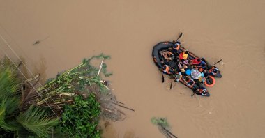 An aerial view shows a coast guard rescue boat evacuating residents in Polangui town, Albay, the Philippines, Oct. 23, 2024. (AFP Photo)