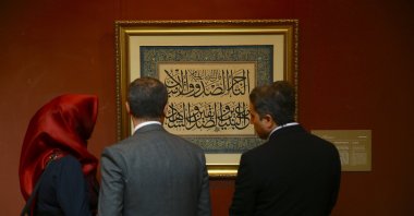 Visitors examine the artworks at the &quot;Heritage Beyond Time: The Silk Road&quot; exhibition in Baku, Azerbaijan, Oct. 22, 2024. (AA Photo)