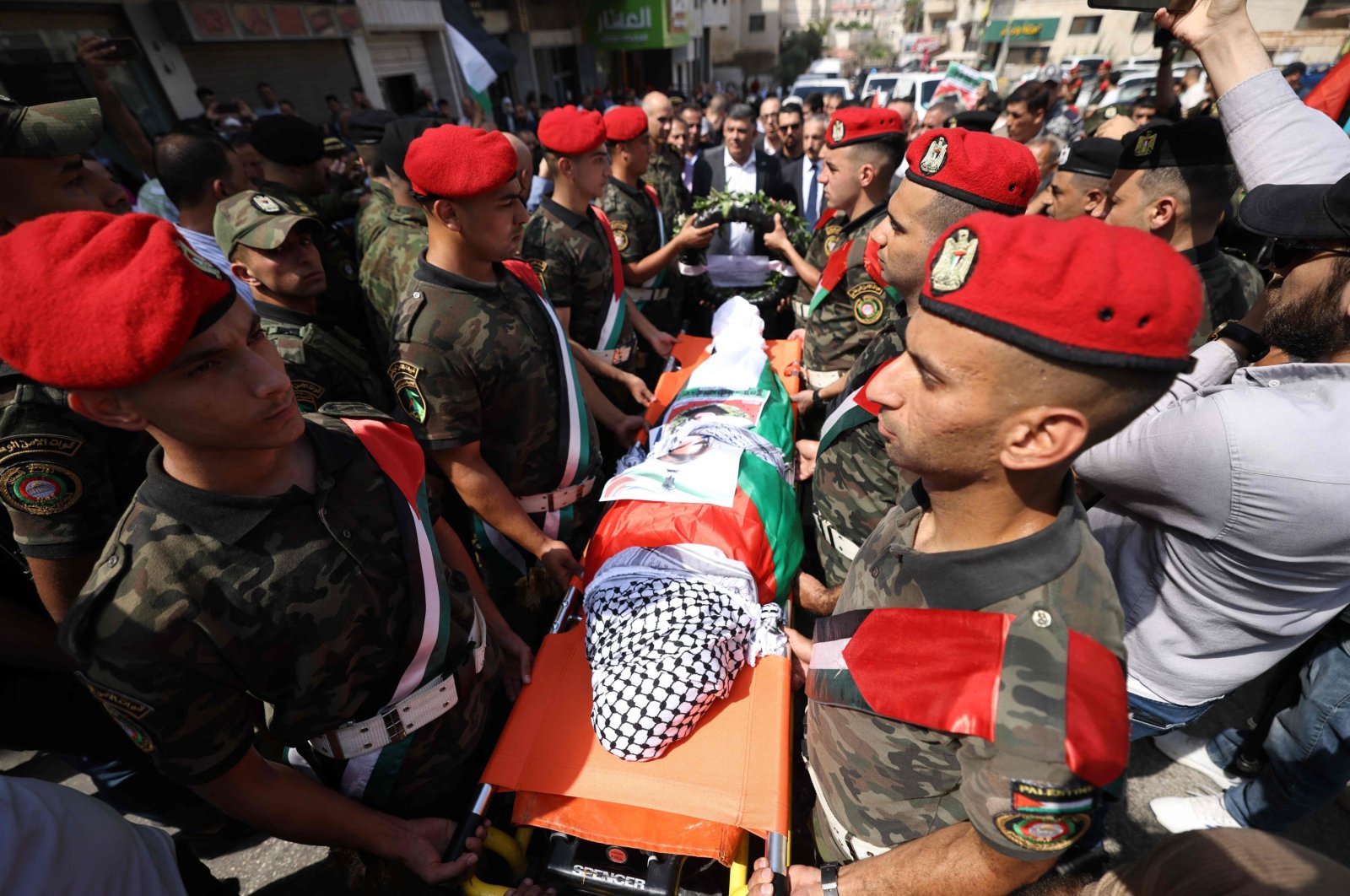 Palestinian security forces carry the body of slain Turkish American activist Aysenur Ezgi Eygi, covered with a chequered keffiyeh and the Palestinian flag, during a memorial service, occupied West Bank, Palestine, Sept. 9, 2024. (AFP Photo)