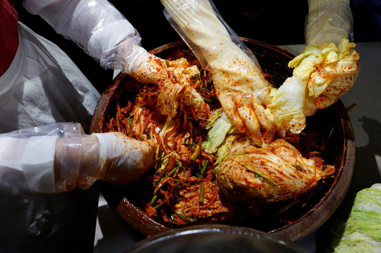 Lee Ha-yeon, a recognized kimchi grand master, and her apprentices prepare kimchi at the Kimchi Culture Institute in Namyangju, South Korea, Aug. 21, 2024. (Reuters Photo)