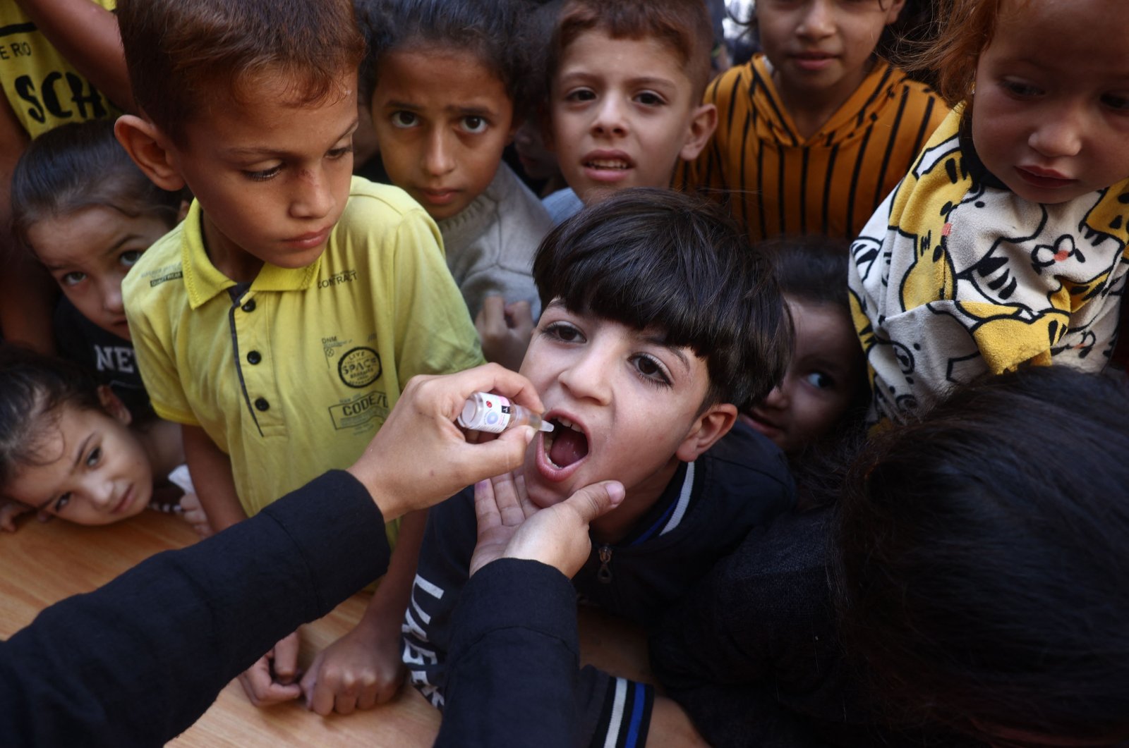 A medic administers a polio vaccine to a Palestinian child in Khan Younis in the southern Gaza Strip, Palestine, Oct. 19, 2024. (AFP Photo)