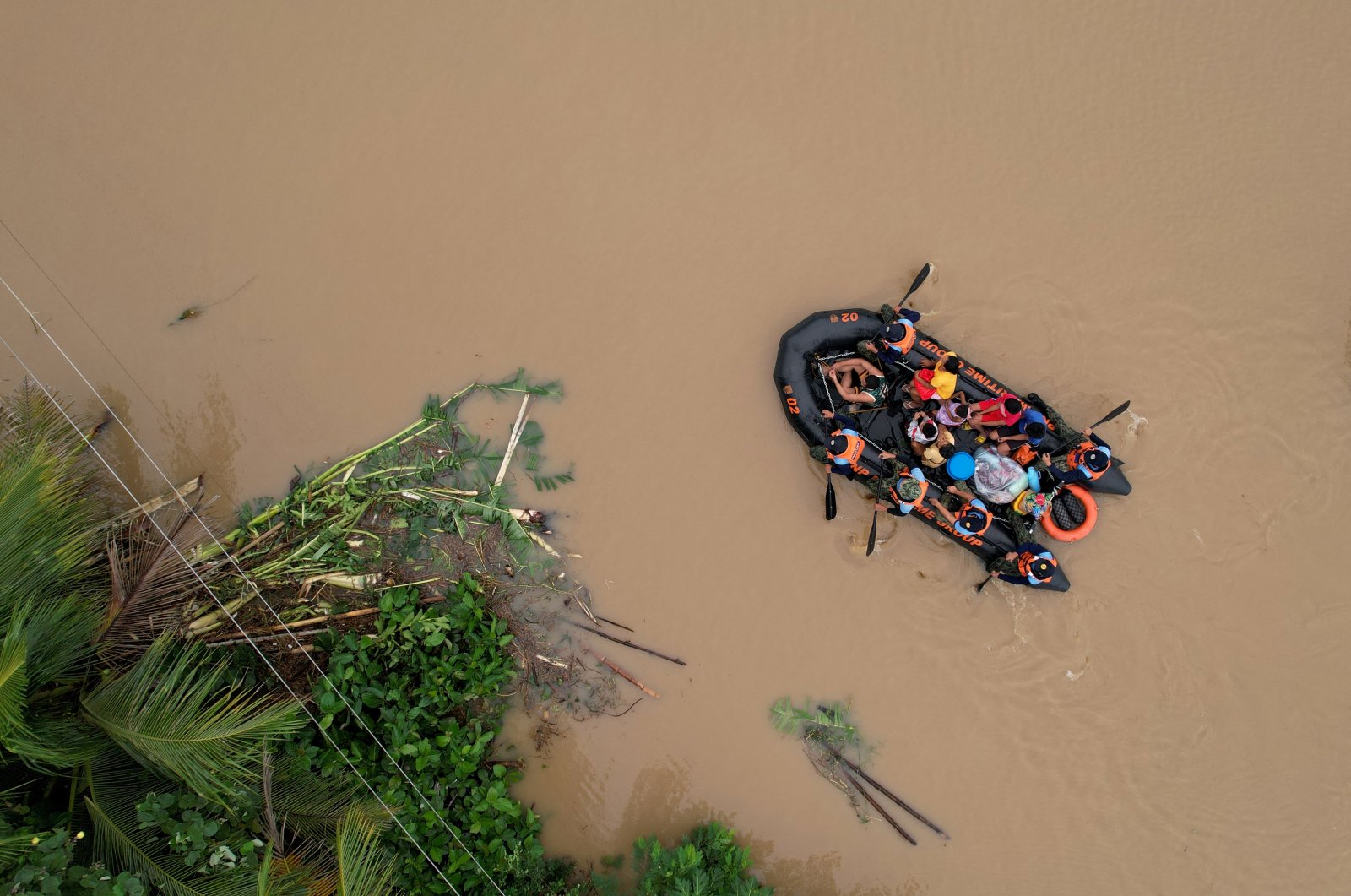 An aerial view shows a coast guard rescue boat evacuating residents in Polangui town, Albay, the Philippines, Oct. 23, 2024. (AFP Photo)