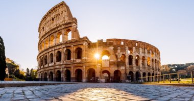 Sunlight streams through the arches of the Colosseum at sunrise, Rome, Italy, April 8, 2024. (Getty Images)