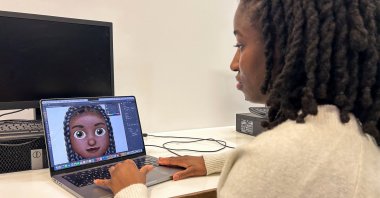 Designer Vanita Brown looks at the final version of one of the Afro hair emojis at the Concorde Youth Club, Hackney, east London, U.K., Oct. 21, 2024. (Reuters Photo)