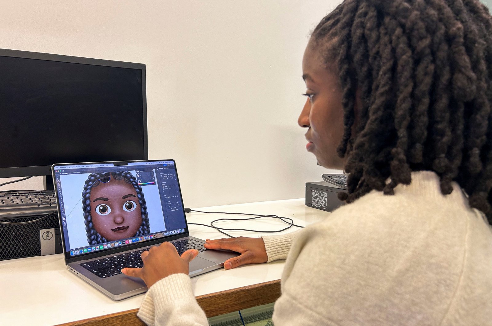 Designer Vanita Brown looks at the final version of one of the Afro hair emojis at the Concorde Youth Club, Hackney, east London, U.K., Oct. 21, 2024. (Reuters Photo)