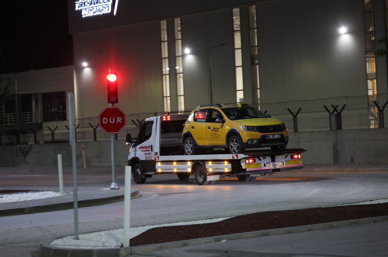 A truck removes a taxi cab that was used by suspects in a terrorist attack at the Turkish Aerospace Industries (TAI) headquarters, Ankara, Türkiye, Oct. 23, 2024. (EPA Photo)