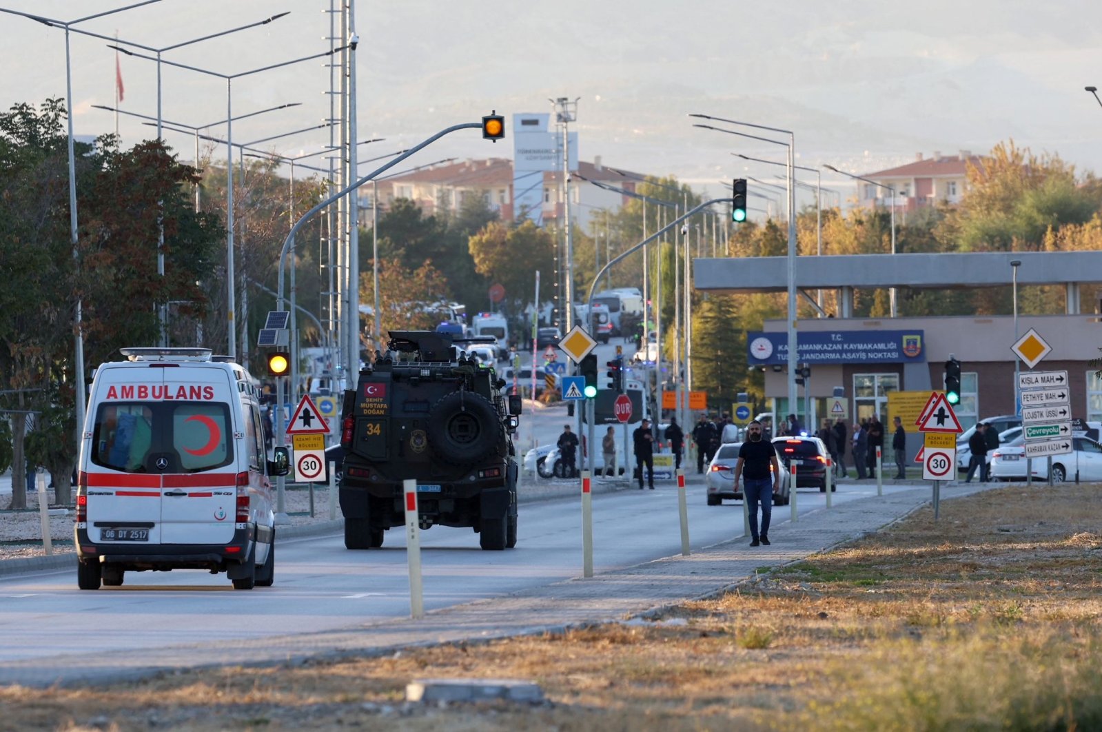 An armored personnel vehicle and an ambulance move along a road in Kahramankazan near the gate of the Turkish Aerospace Industries (TAI) after a terrorist attack in Ankara, Türkiye, Oct. 23, 2024. (AFP Photo) 