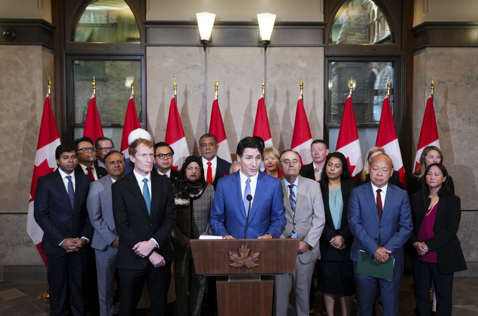 Prime Minister Justin Trudeau and Immigration, Refugees and Citizenship Minister Marc Miller are joined by fellow members of Parliament as they hold a press conference on Parliament Hill in Ottawa, Canada, Oct. 24, 2024. (The Canadian Press via AP)