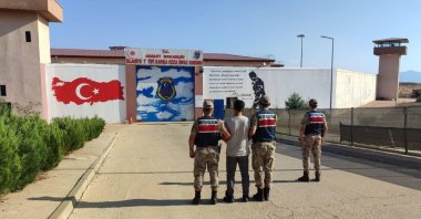 Gendarmerie officers escort a PKK suspect charged with spreading terrorist propaganda to a prison in Gaziantep province, southeastern Türkiye, Oct. 16, 2024. (IHA Photo)