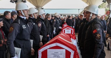 A Turkish police honor guard stands next to the coffins of Zahide Güçlü Ekici, Hasan Huseyin Canbaz and Cengiz Coşkun during their funeral, the day after they were killed in a terrorist attack on the state-run Turkish Aerospace Industries (TAI) building, Ankara, Türkiye, Oct. 24, 2024. (AFP Photo)