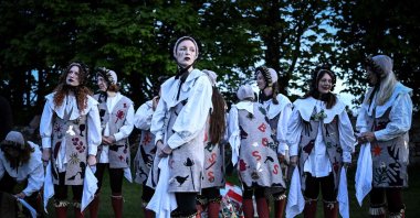 Members of the Boss Morris dancing group look on as they prepare to dance during sunrise as part of the May Day celebrations tradition, at Rodborough Common, Stroud, U.K., May 1, 2024. (AFP Photo)