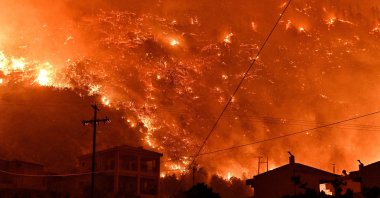 Flames rise as a wildfire burns next to the village of Ano Loutro, near Corinth, Greece, Sept. 29, 2024. (Reuters Photo)