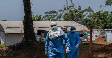 Two workers from the NGO Alima walk in the courtyard of the mpox treatment center, Kamituga, South Kivu, Democratic Republic of Congo, Sept. 20, 2024. (AFP Photo)