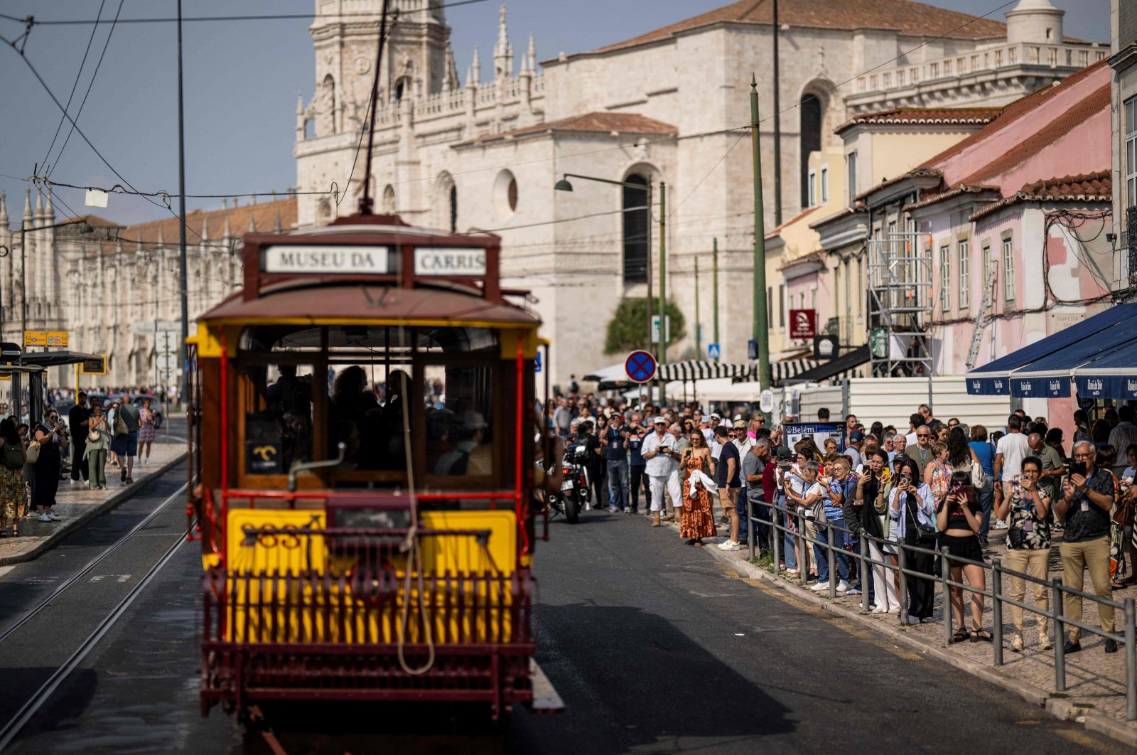 Tourists take pictures as the historical trams of Carris (Lisbon’s public transport) take part in the annual parade of classical trams and buses in celebration of the 152nd anniversary of the company, Lisbon, Portugal, Sept. 21, 2024. (AFP Photo)