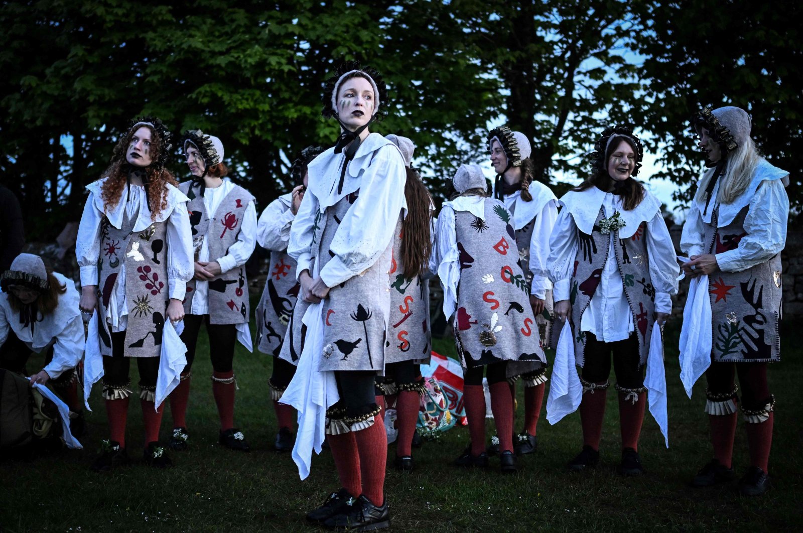 Members of the Boss Morris dancing group look on as they prepare to dance during sunrise as part of the May Day celebrations tradition, at Rodborough Common, Stroud, U.K., May 1, 2024. (AFP Photo)