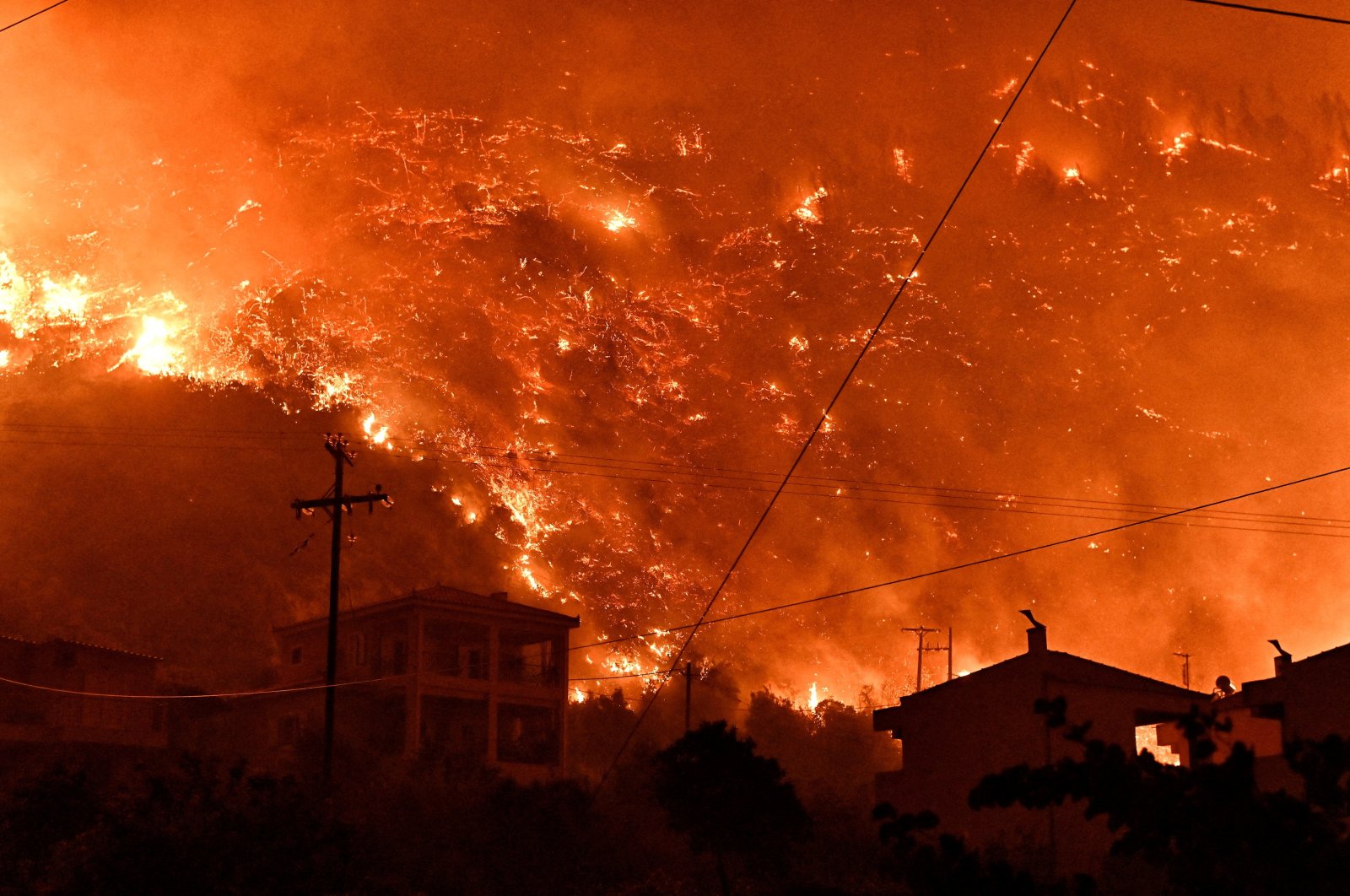 Flames rise as a wildfire burns next to the village of Ano Loutro, near Corinth, Greece, Sept. 29, 2024. (Reuters Photo)