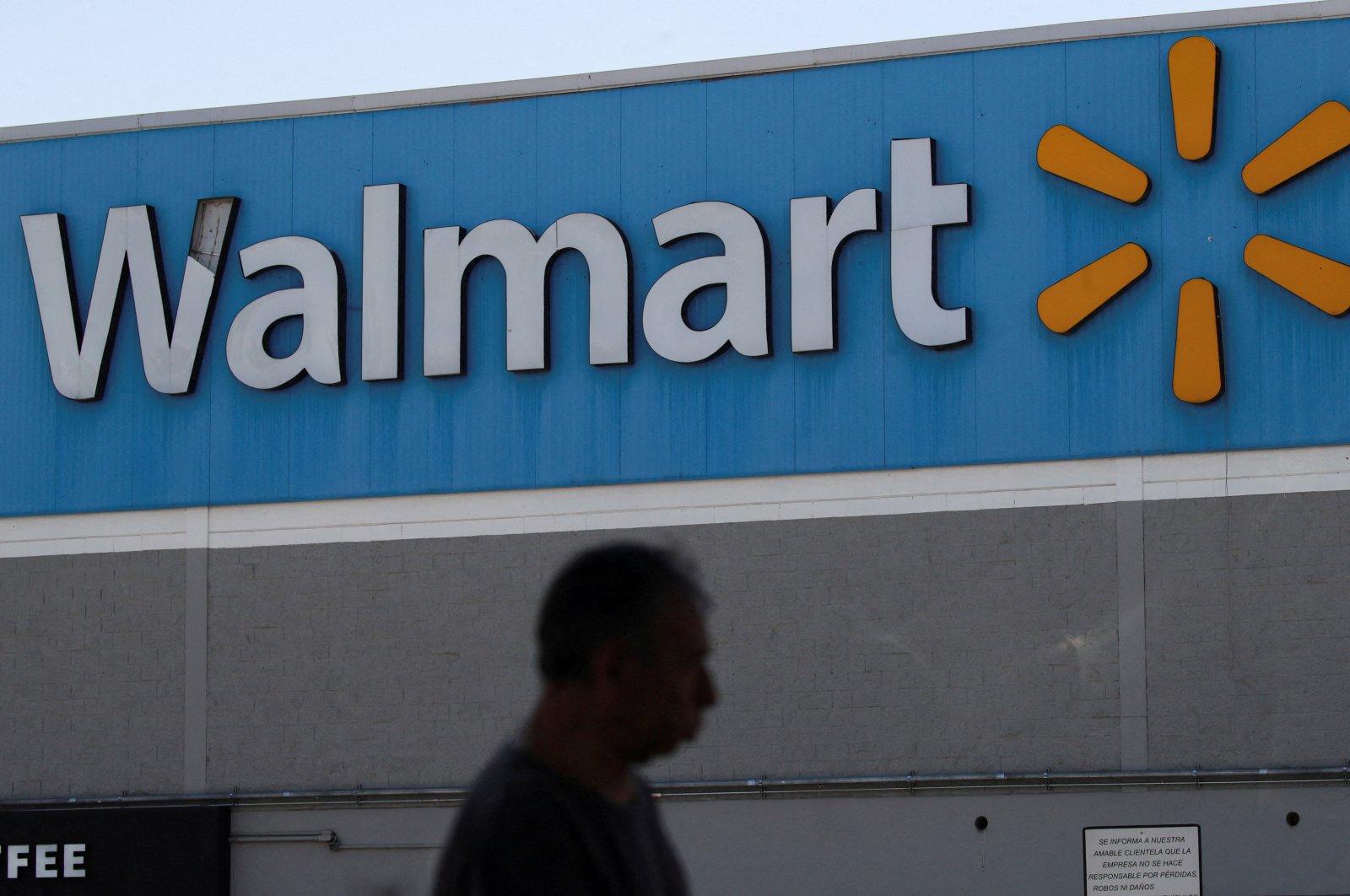 A man walks past the logo of Walmart on the facade at a store in Mexico City, Mexico June 17, 2024. (Reuters Photo)