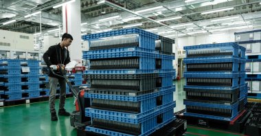A worker moves battery cells to be packed for shipment at the battery manufacturing plant at PT HLI Green Power, Indonesia&#039;s first EV battery cell manufacturer, Karawang, West Java, Indonesia, Aug. 28, 2024. (AFP Photo)