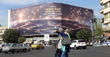 Iranian women walk near an anti-Israel billboard depicting Iran's recent missile attack on Israel in Tehran, Iran, Oct. 26, 2024. (EPA Photo)