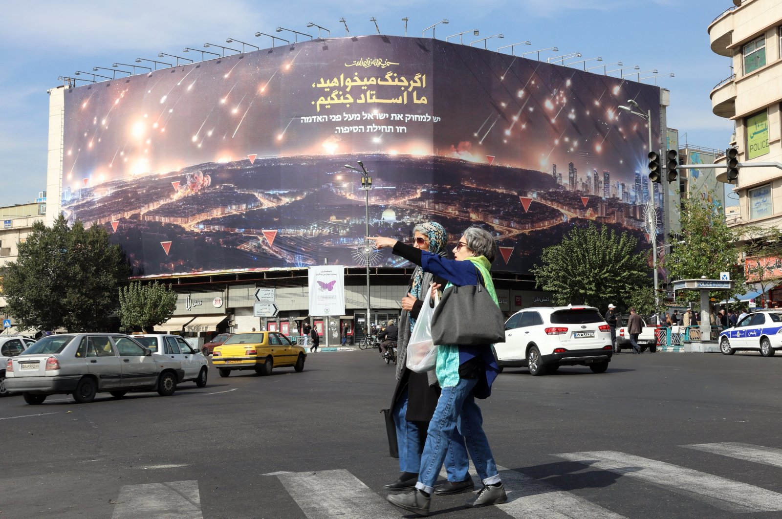 Iranian women walk near an anti-Israel billboard depicting Iran&#039;s recent missile attack on Israel in Tehran, Iran, Oct. 26, 2024. (EPA Photo)