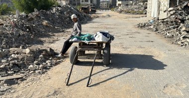 A wounded Palestinian rests on a cart transporting bodies, killed in an overnight Israeli airstrike, in Beit Lahia the northern Gaza Strip, Palestine, Oct. 27, 2024. (AFP Photo)