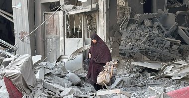 A woman walks above the rubble of a building following an Israeli strike in Beit Lahia in the northern Gaza Strip, Palestine, Oct. 28, 2024. (AFP Photo)