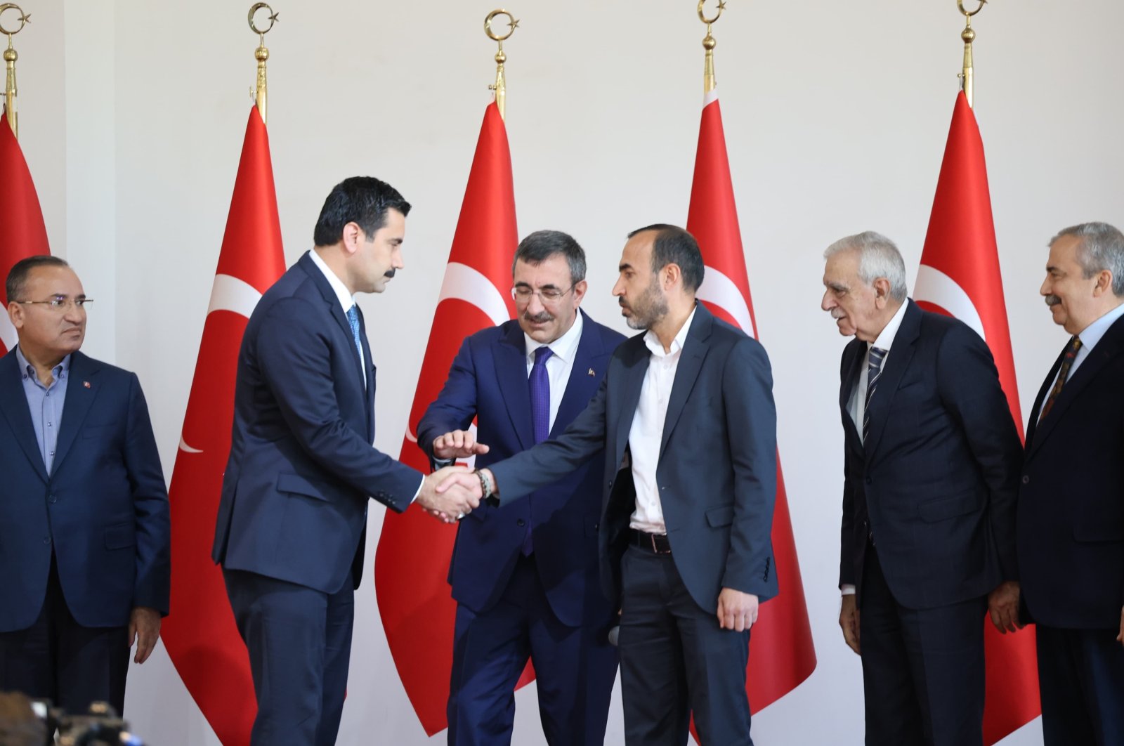 Ferit Şenyaşar (R) and Ibrahim Halil Yıldız (L) shake hands as VP Cevdet Yılmaz stands between them and AK Party&#039;s Bekir Bozdağ (L) and DEM Party&#039;s Ahmet Türk (2nd R) and Sırrı Süreyya Önder (R) look on, Şanlıurfa, southeastern Türkiye, Oct. 27, 2024. (DHA Photo)