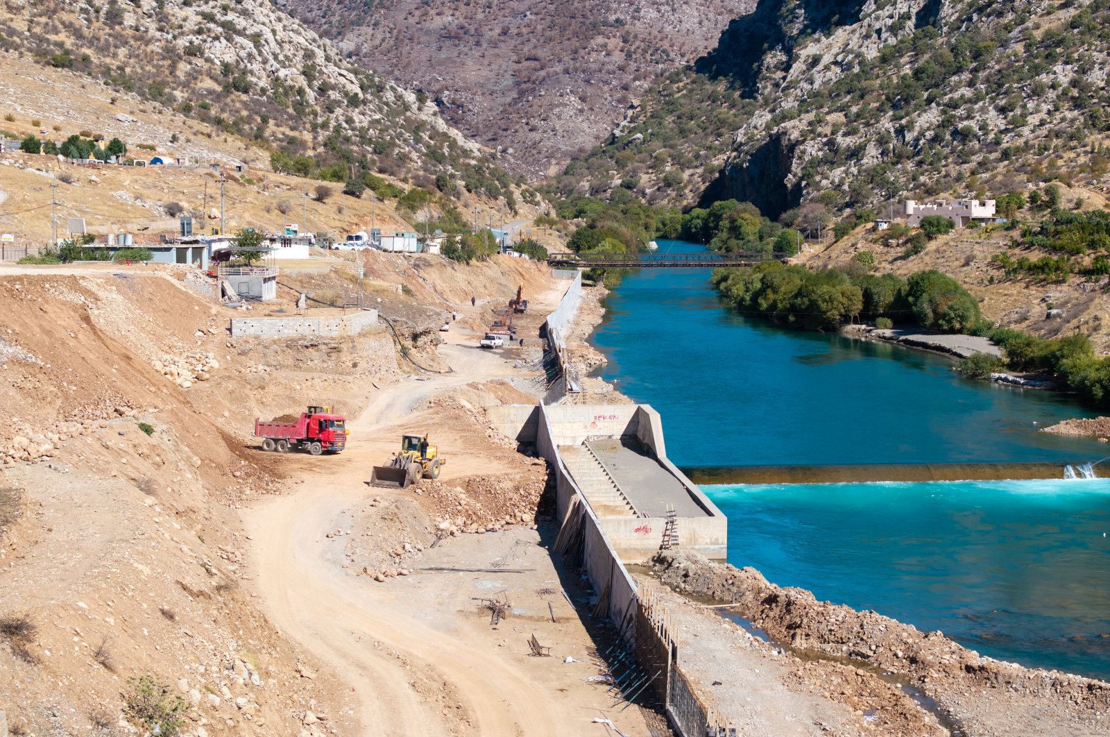 Bulldozers and trucks working on the coast of Great Zab in Sheladiz, Duhok, Iraq, Oct. 28, 2024. (AA Photo)