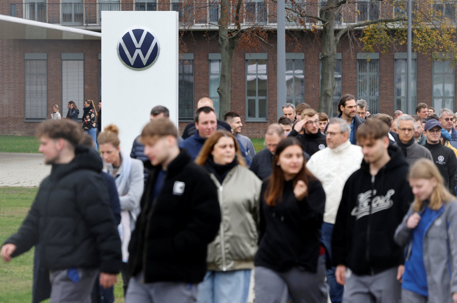 Employes walk following the announcement of Volkswagen AG job cuts and closure of its few factories, at the company&amp;#039;s headquarters in Wolfsburg, Germany, Oct. 28, 2024. (Reuters Photo)