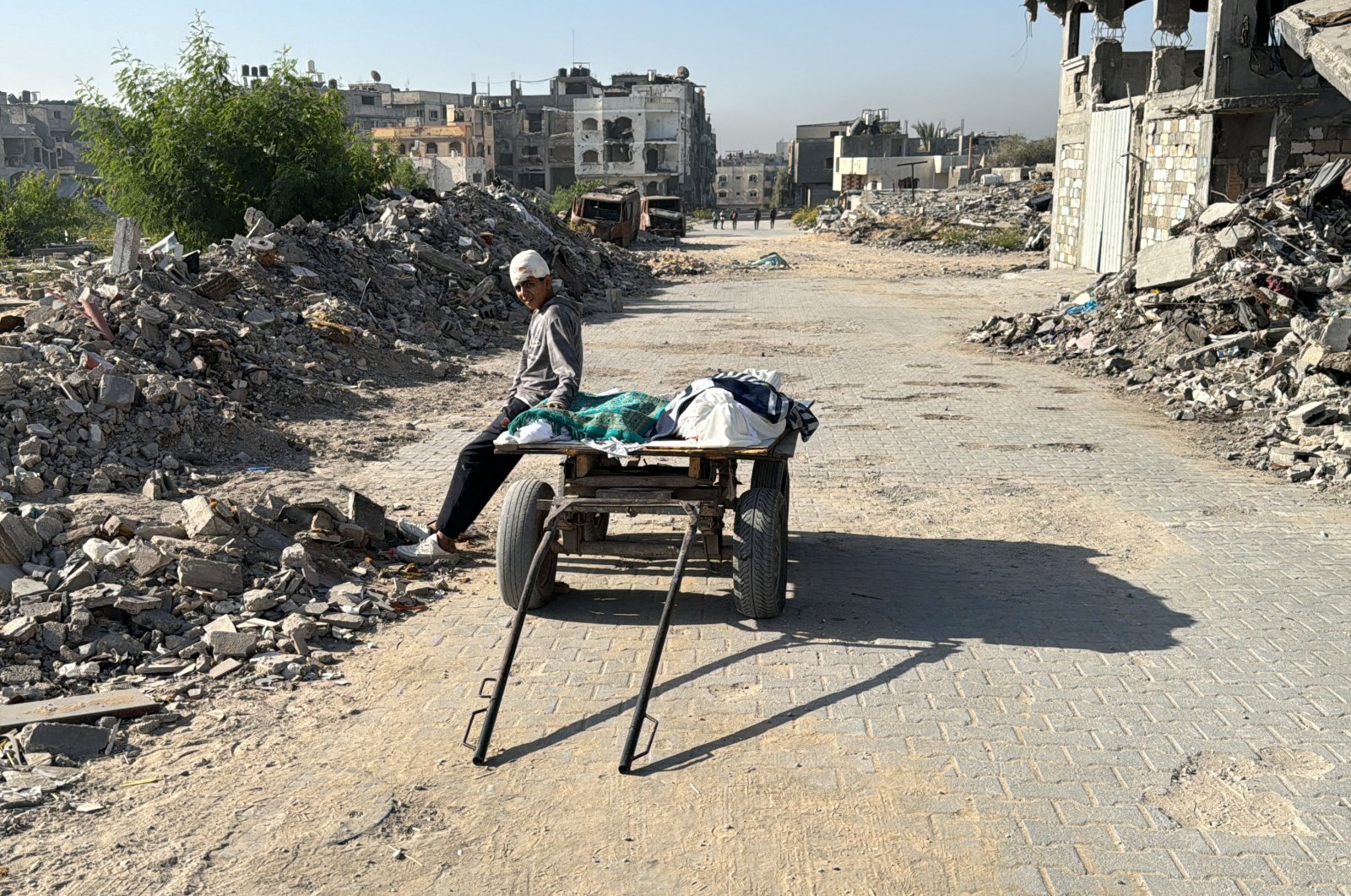 A wounded Palestinian rests on a cart transporting bodies, killed in an overnight Israeli airstrike, in Beit Lahia the northern Gaza Strip, Palestine, Oct. 27, 2024. (AFP Photo)