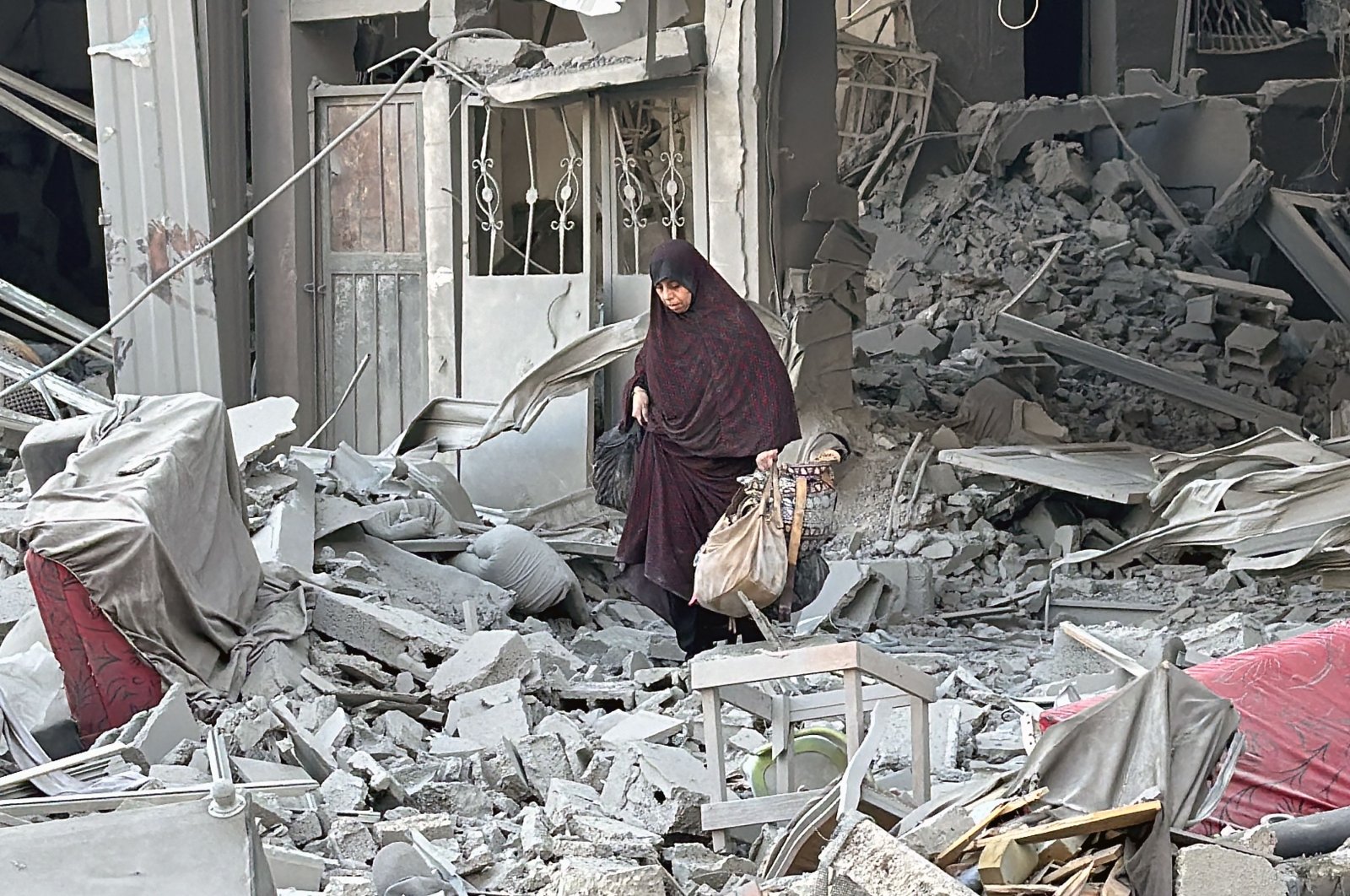 A woman walks above the rubble of a building following an Israeli strike in Beit Lahia in the northern Gaza Strip, Palestine, Oct. 28, 2024. (AFP Photo)