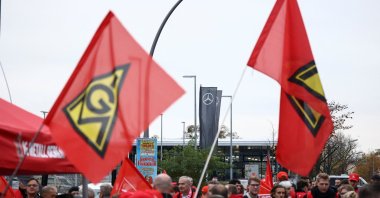 A view of flags with the logo of the German car maker Mercedes and union IG Metall during a protest rally by Mercedes employees at a Mercedes plant, Berlin, Germany, Oct. 29, 2024. (Reuters Photo)