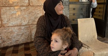 Sade Gorli, a Lebanese Turkman, holds her granddaughter during an interview in the Duris of Baalbek region, Lebanon, Oct. 25, 2024. (AA Photo)