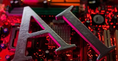 AI (Artificial Intelligence) letters are placed on computer motherboard in this illustration taken on June 23, 2023. (Reuters Photo)