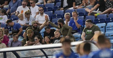 Ukrainian serviceman of the Azov Brigade, also known by the call sign "Escobar" (C-L), celebrates a goal of Dynamo Kyiv during a football match with Zorya Luhansk, Kyiv, Ukraine, Sept. 14, 2024. (AP Photo)