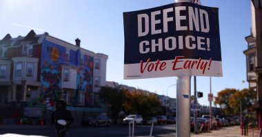 A person walks past a sign encouraging people to vote early in the upcoming U.S. presidential election, in Philadelphia, Pennsylvania, U.S., Oct. 25, 2024. (Reuters Photo)